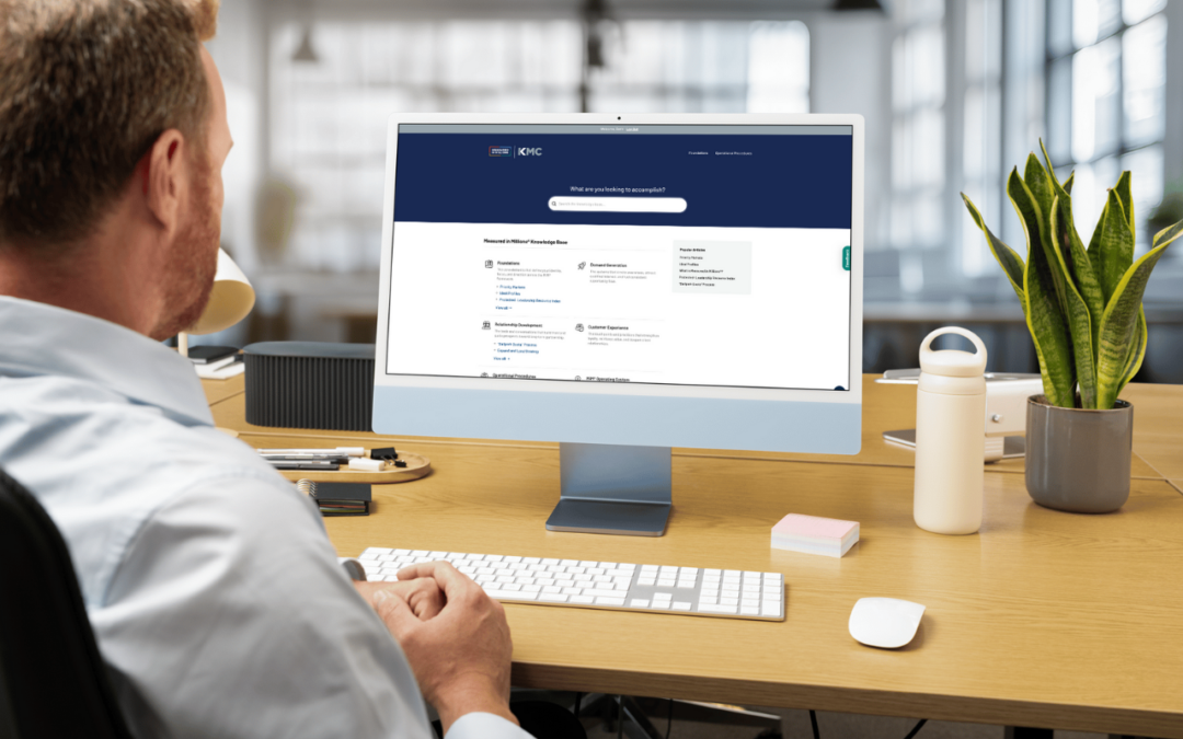 Man looking at a computer on a desk.