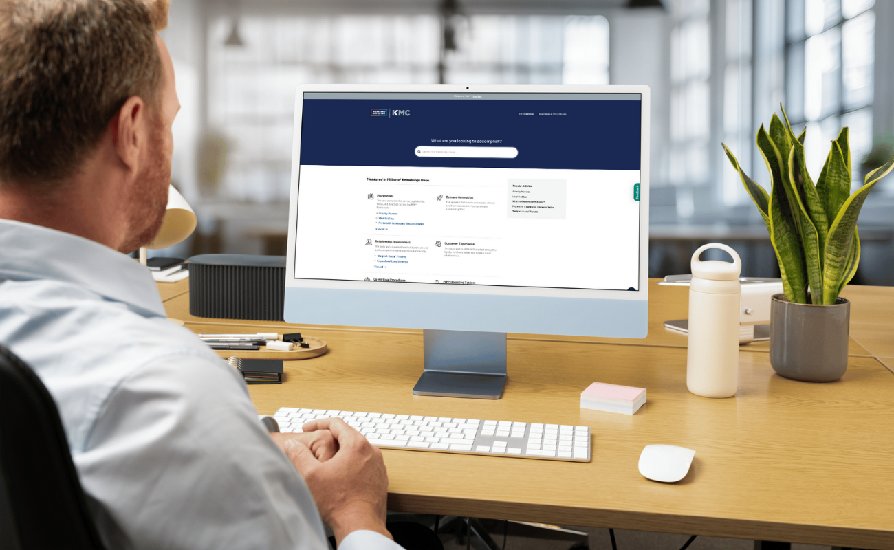 Man looking at a computer on a desk.