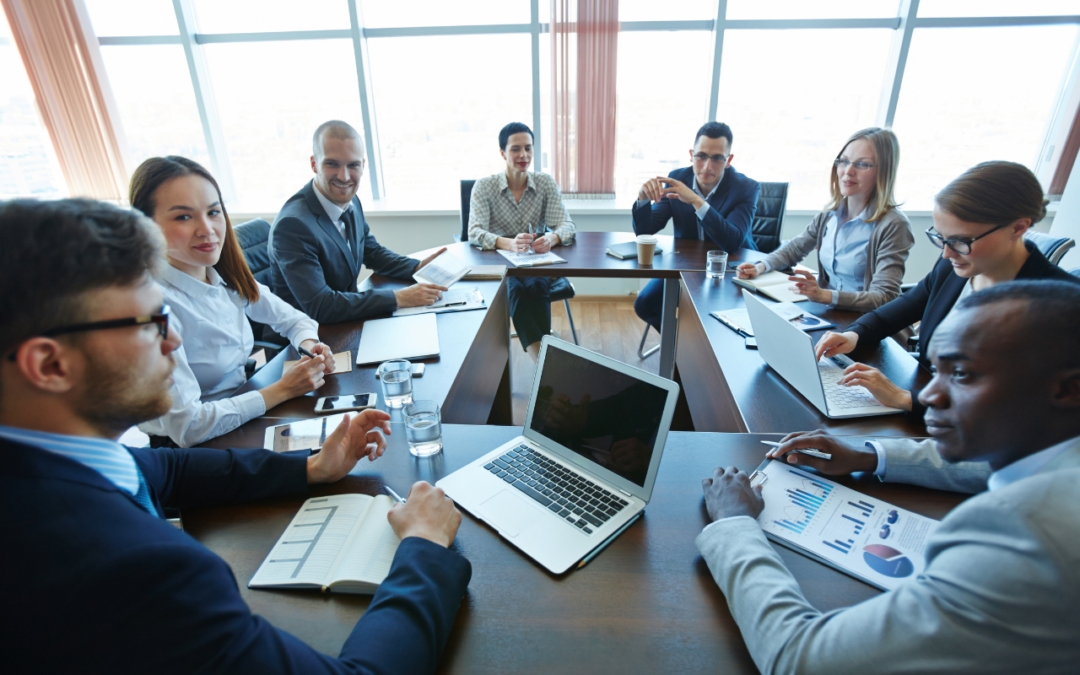 Group of professionals collaborating at a square table setup.