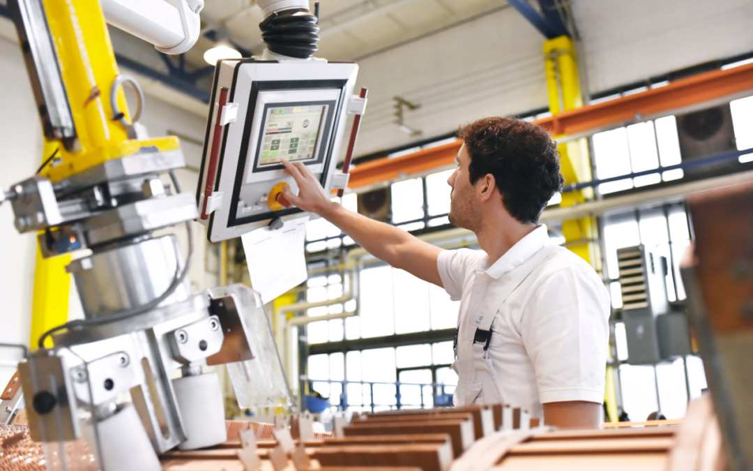 Man using computer display while operating machinery.