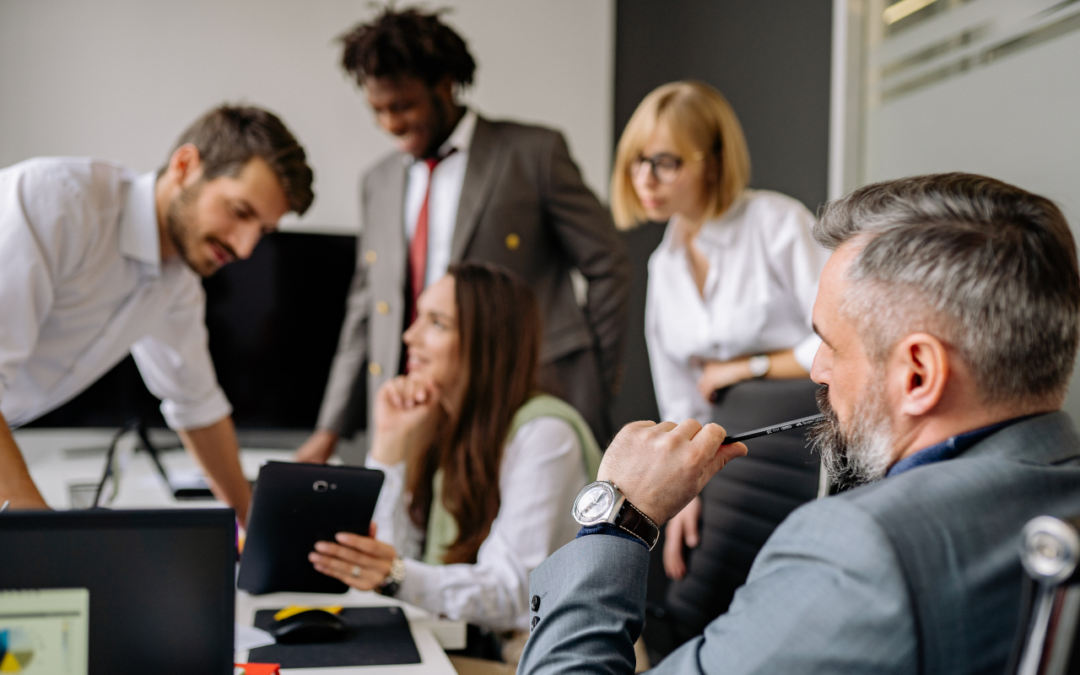Group of business professionals working together at a table.