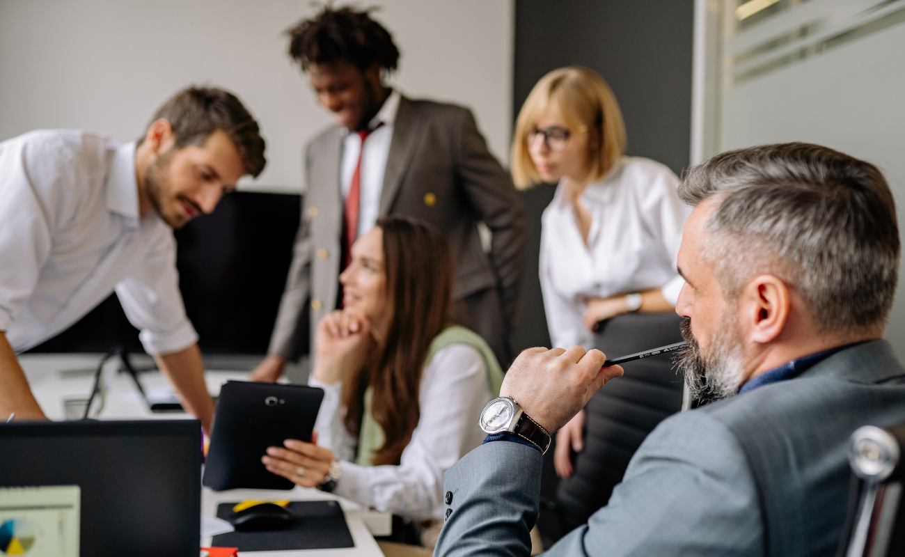 Group of business professionals working together at a table.
